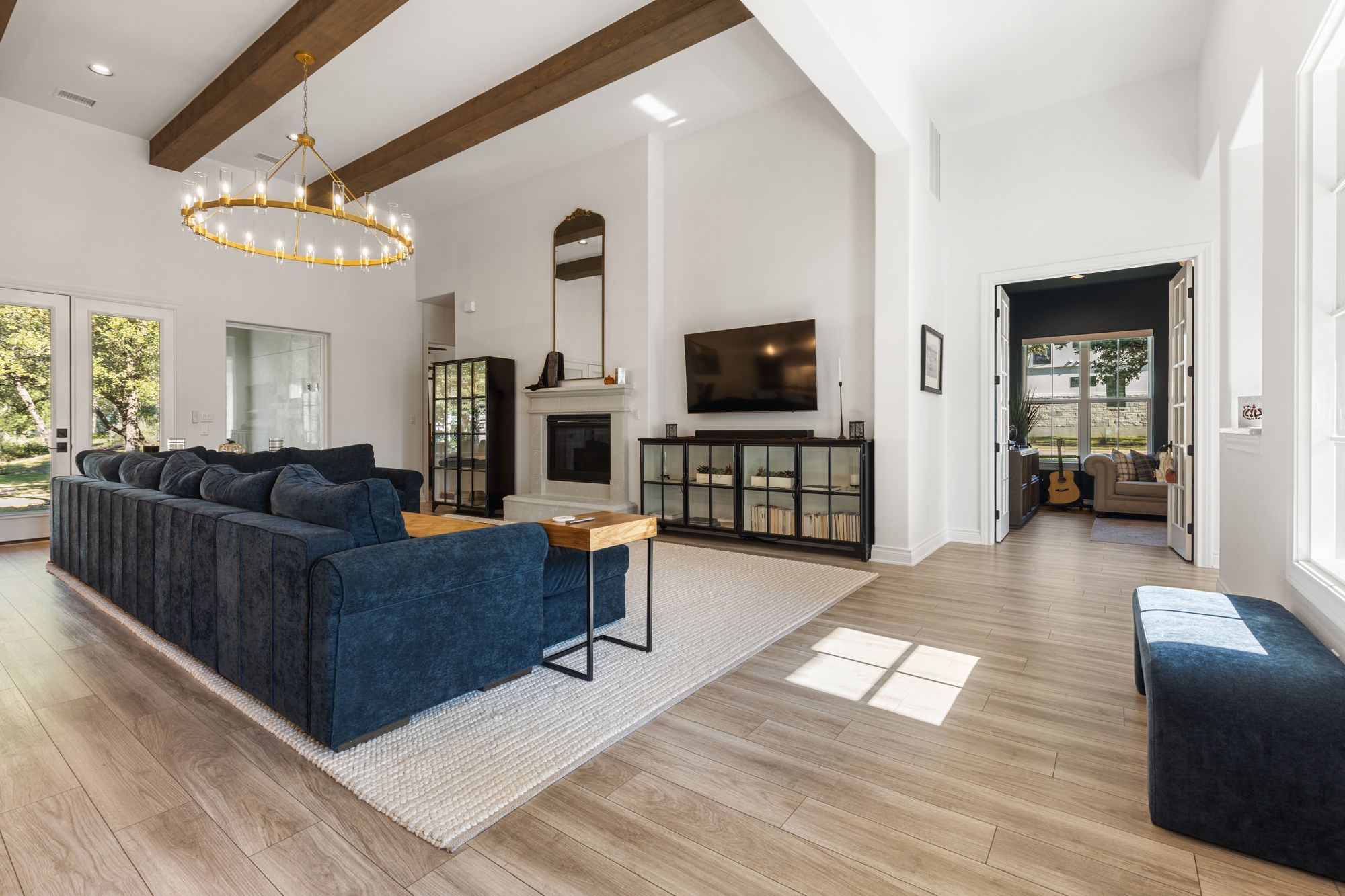 Living room with the gas fireplace and round chandelier