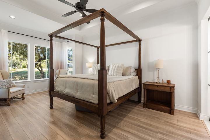 Primary bedroom with windows to the yard