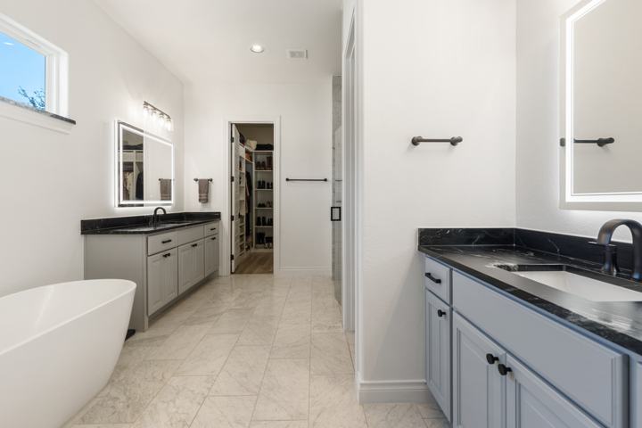 Primary bath with the marble shower and soaking tub