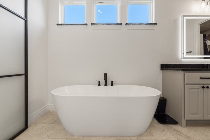 Primary bath with a freestanding tub under clerestory windows
