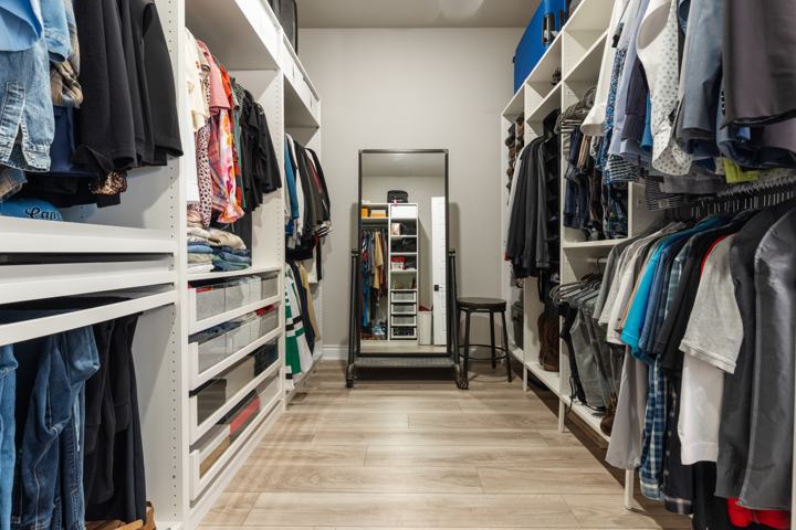 Primary walk-in closet with built-in shelving