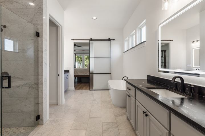 Primary bath toward the shower and barn door