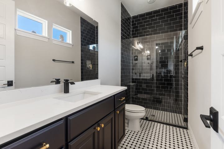 Casita bath with a black tile shower