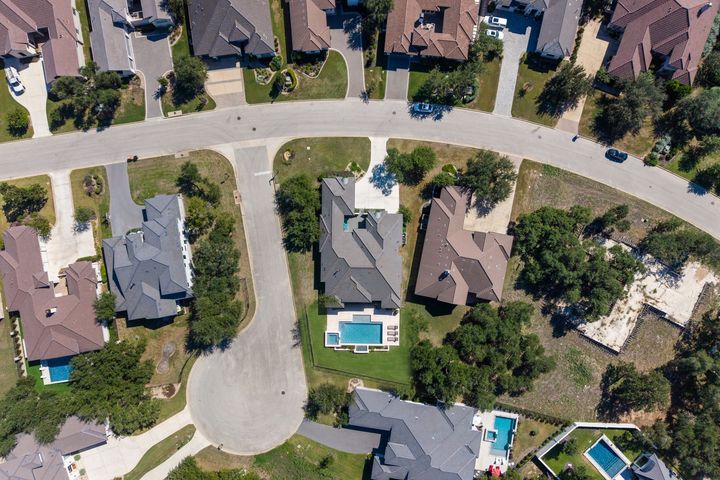 Concept rendering: overhead view of the lot with a pool and a fenced back yard; neighboring trees unchanged